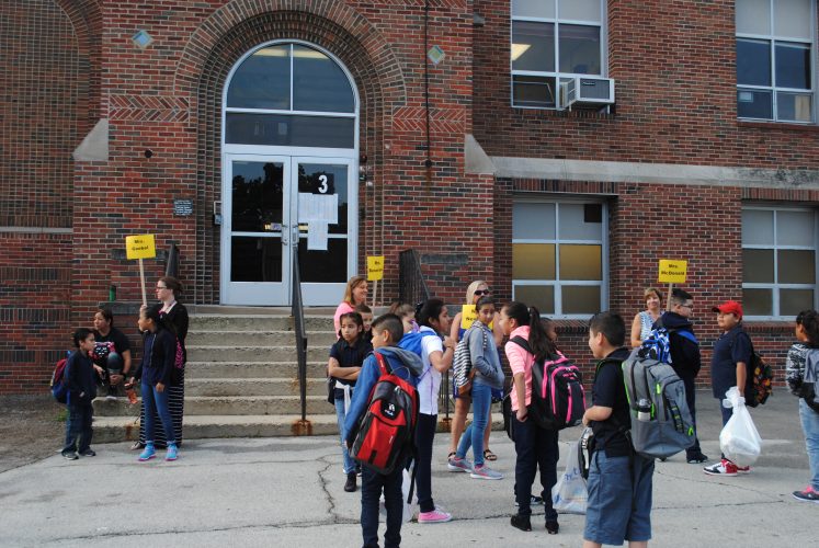 Students lined up by their teacher.