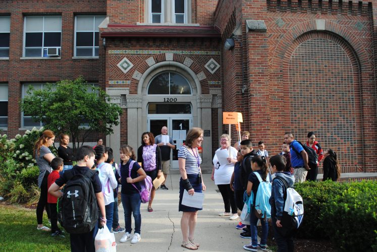 Students lined up by their teacher.