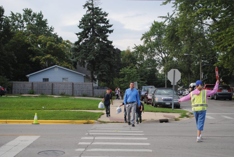 A family crossing the street.